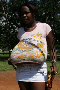 black babe Miosotis Claribel shows off her big tanned Hooters free photos